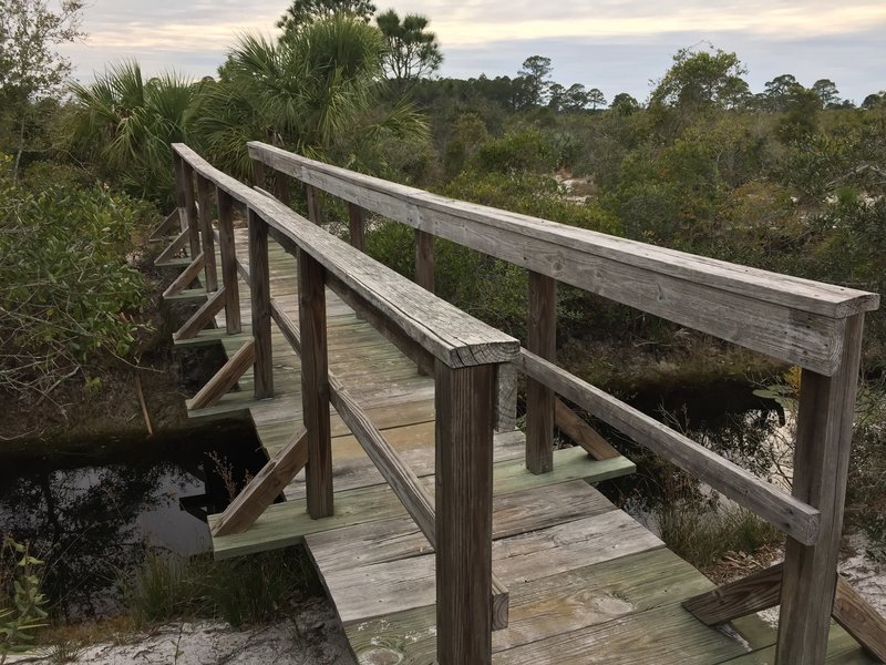 A sturdy footbridge aids your passage across the short canal.