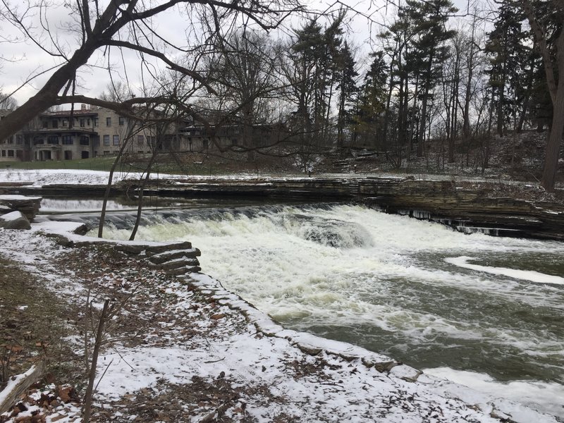 A broad waterfall cascades behind Henry Ford Estates.