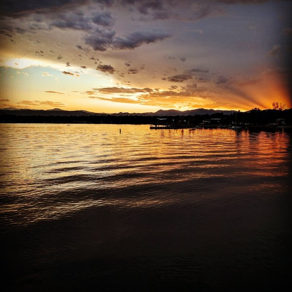 The sun sets over Sloan's Lake Park.