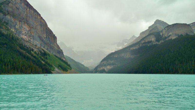 Lake Louise poses with Victoria Glacier at its far end and Mt. Victoria hidden in the clouds.