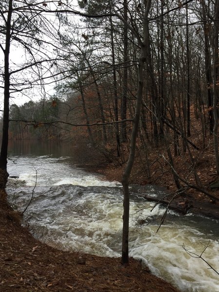 Water flows heavily from the creek into Stone Mountain Lake after a couple days of rain.