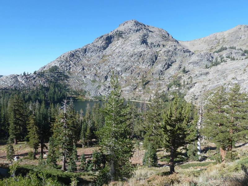 4th of July Lake stands in the shadow of a barren, granite peak.