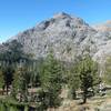 4th of July Lake stands in the shadow of a barren, granite peak.