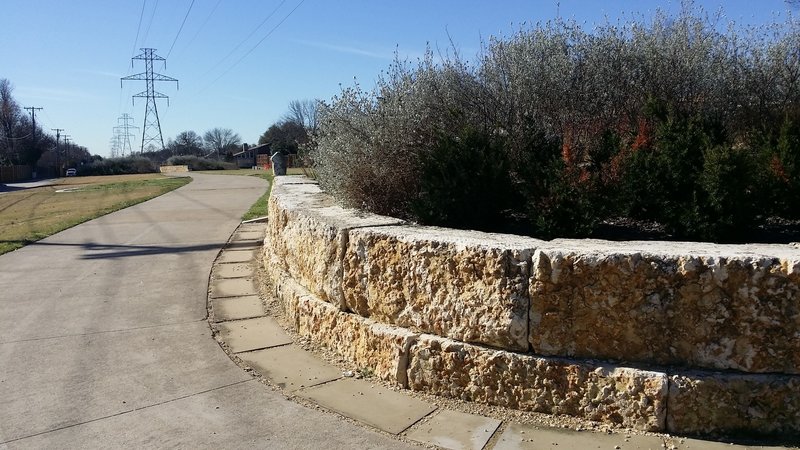 Well-maintained planters adorn the trail.