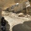 A large rock arch creates a bridge between the canyon walls.