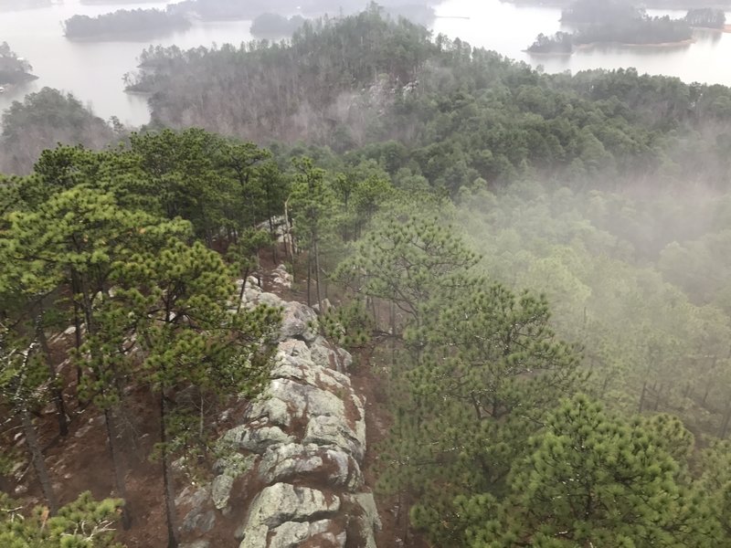 A fog rolls over the ridge below the fire tower.