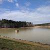 The lake level looks low on a cloudy spring day.