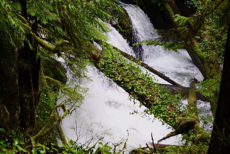 Smaller waterfalls continue to cascade at the foot of the main one.