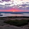 The sun rises over Cadillac Mountain and the archipelago.