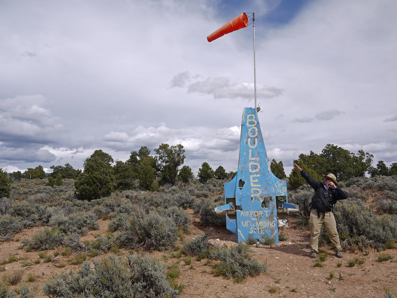 A wind sock stands as one of the only landing aids at the uncontrolled Boulder Landing Strip.