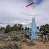 A wind sock stands as one of the only landing aids at the uncontrolled Boulder Landing Strip.