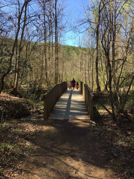 A sturdy bridge crosses a feeder stream that eventually joins Smith Creek.