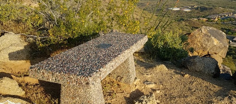 The Eastwing Mountain Trail hosts a pleasant memorial bench on which you can sit, reflect, and enjoy the view.