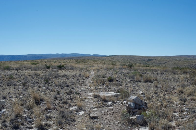 Cairns and posts mark the path as it makes its way toward the visitor center, which sits off in the distance.