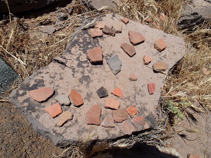 Pottery sherds are abundant around the dwelling.