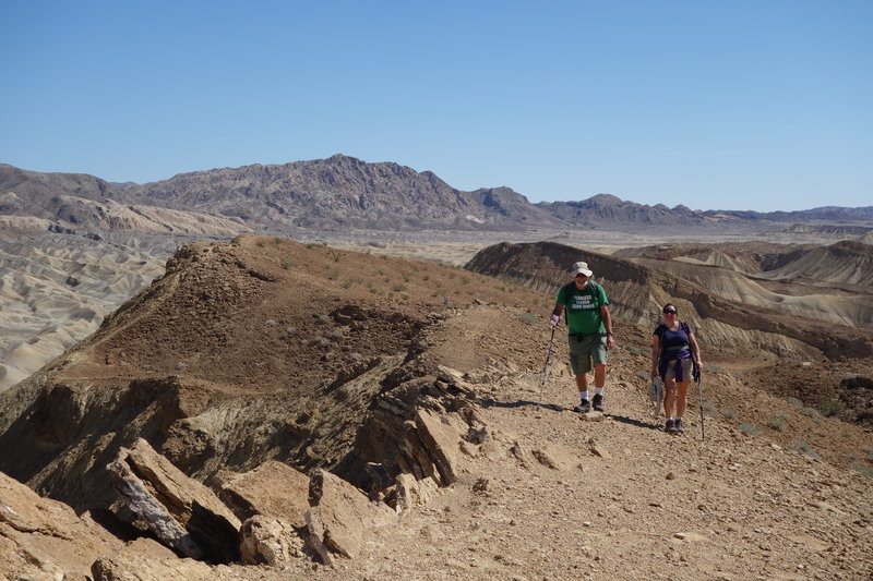 Two hikers ascend the Elephant Knees ridge.