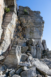 The trail is inundated with rockfall underneath the cliff.