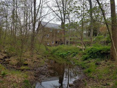 Cooper Grist Mill seen through the trees along the Black River Trail.