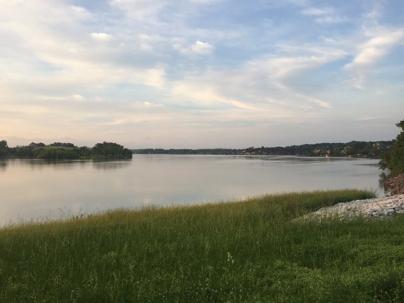 Enjoy a beautiful view from the saddle dam looking south toward Tellico Village. The Smoky Mountains are partially visible over the treeline on the left side of the image. The mountains would be more visible on a clear day.