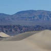 Crescent dunes are framed by the mountains to the west.