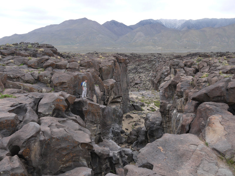 A hiker admires the top of Fossil Falls.