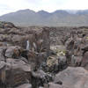 A hiker admires the top of Fossil Falls.