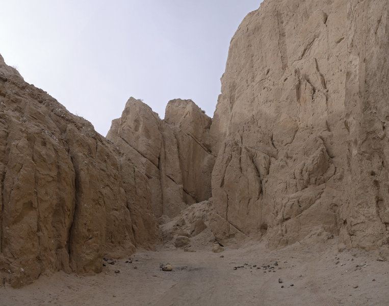 Scored mud marks the mouth of the slot canyon.