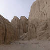 Scored mud marks the mouth of the slot canyon.