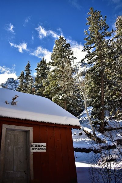 Not much remains of the mine but the bunkhouse, blacksmith shop, an outhouse, mining cables and a cart, and this office building tucked away beneath the trees.