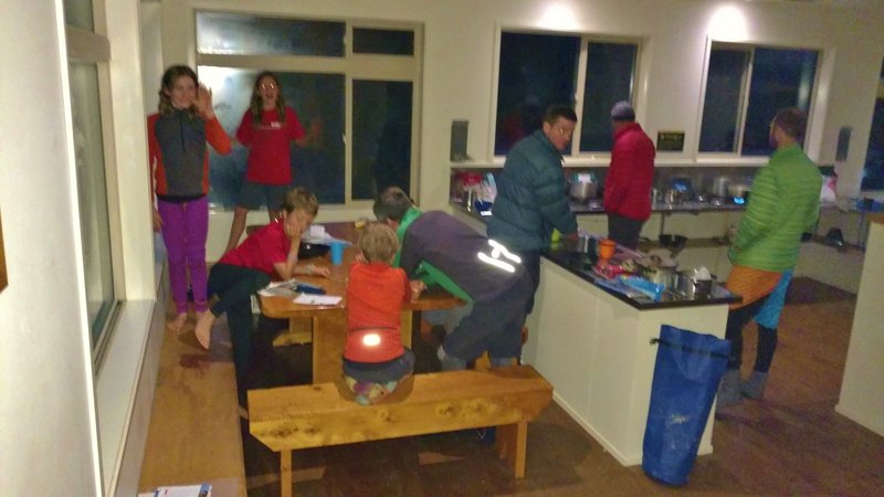 It's dinner time at the well-appointed Perry Saddle Hut on the Heaphy Track. It's May and the days are getting very short.