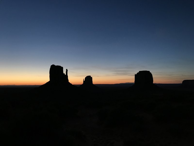 The sun rises over a sleeping Monument Valley.