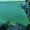 The turquoise waters of Coquille Bay shine from the Abel Tasman Track.