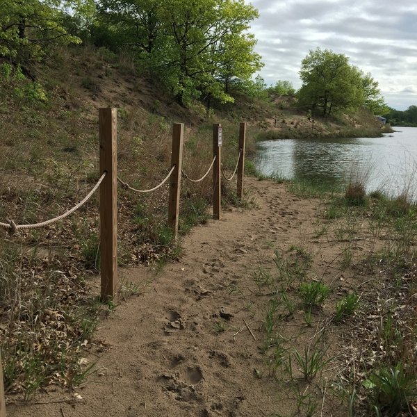 The trail winds around dunes and ponds.