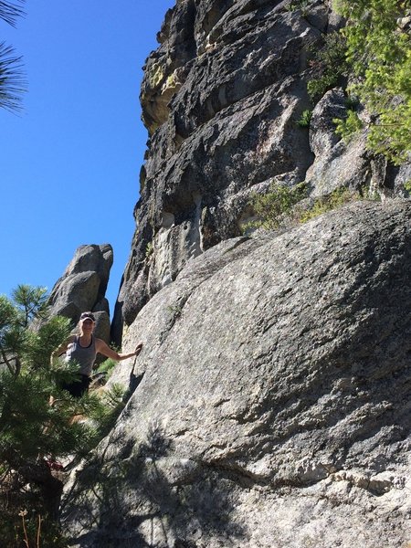 An adventurer checks out the huge rock formation.