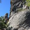 An adventurer checks out the huge rock formation.