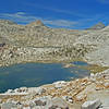 Bighorn Lake shines with Ambition Lake barely visible above it. Mt. Goddard is the dark peak over the ridge. Valor Pass is on the ridge directly in front of it, with Mt. Reinstein on the extreme right.