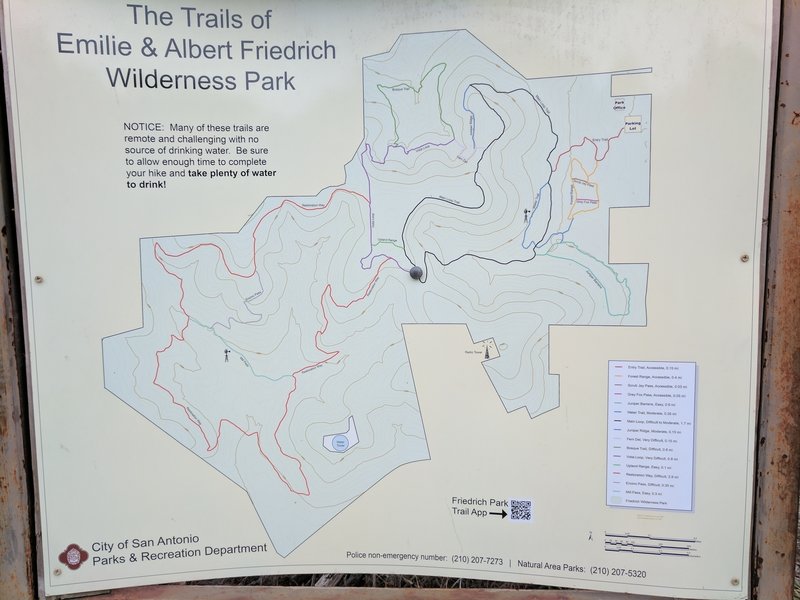 An informative trail map kiosk helps you find your way at this intersection.