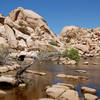 Boulders rise out of the water behind the Barker Dam.