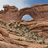 Nevills Arch stands high in the cliffs above.