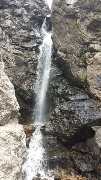 Rocky Mouth Waterfall cascades into a rocky alcove.