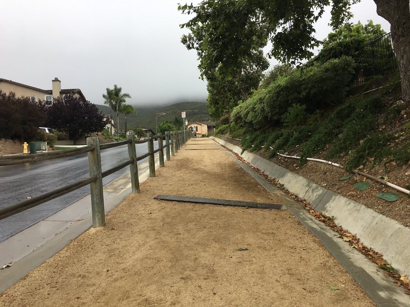 The first section of the Double Peak Trail travels through a neighborhood.