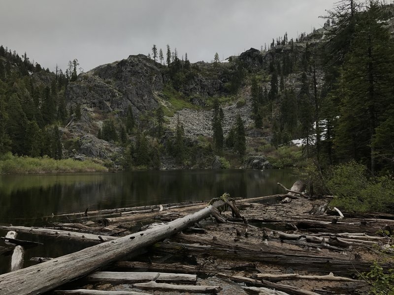 Mill Creek Lake hides in the shadow of a gloomy day in the western Trinity Alps.