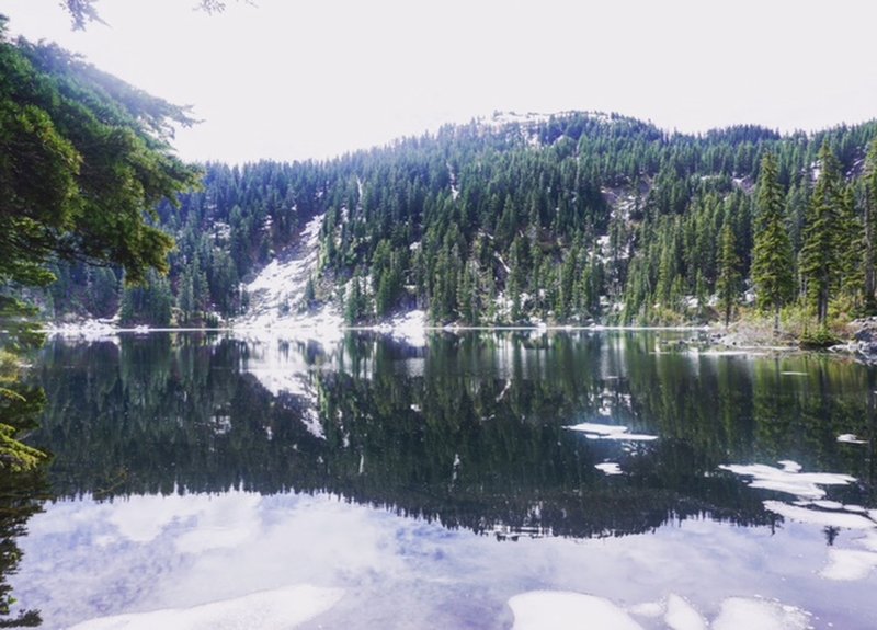 In early summer, almost all of the ice is gone from Mason Lake, leaving a beautiful reflection.