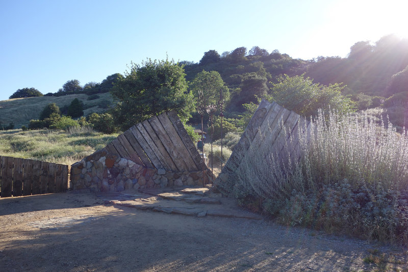 Early morning light shines on the Hubbell Gateway, designed by local artist and architect James Hubbell, at the start of the Volcan Mountain Trail.