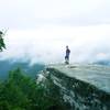 A hiker enjoys her reward on McAfee Knob.