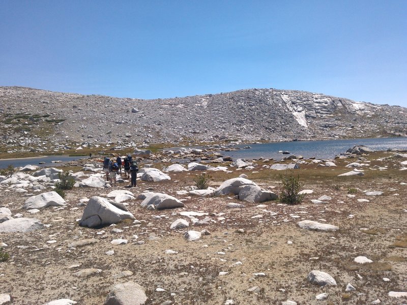 A sunny day brings big smiles to a group near Bighorn Lake on the Blackcap Basin Lakes Route.