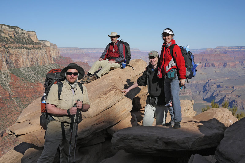 Four hikers take a break at Ooh Aah Point on the South Kaibab Trail.