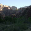 A hiker watches the late-afternoon sun on the canyon wall from near Bright Angel Campground.