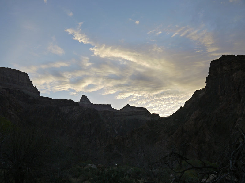 The sun rises over the junction of Bright Angel Canyon and the Colorado River.