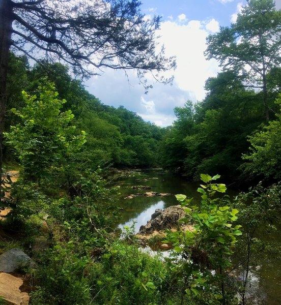 The rocky Eno River flows beside the trail.